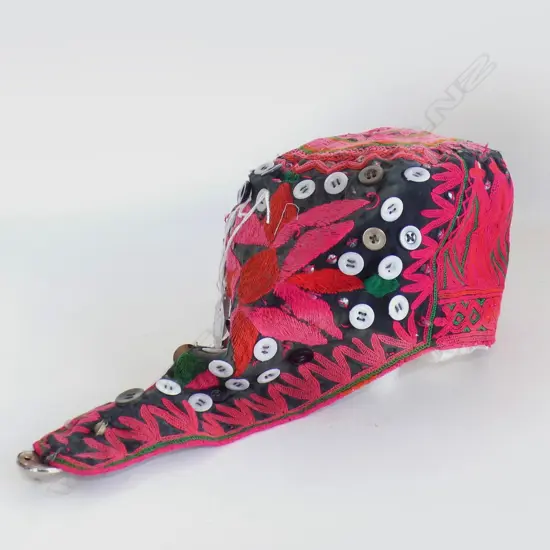 Pink Uzbek womans skull cap with short plait cover.